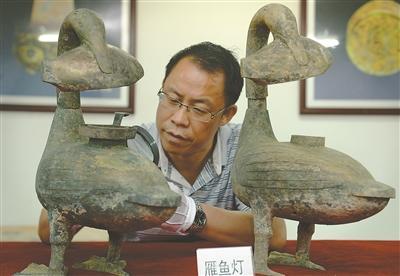 考古人員查看青銅雁魚燈。