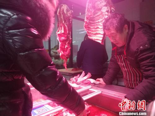 图为北京西城区一家菜市场里的牛羊肉摊。 谢艺观 摄